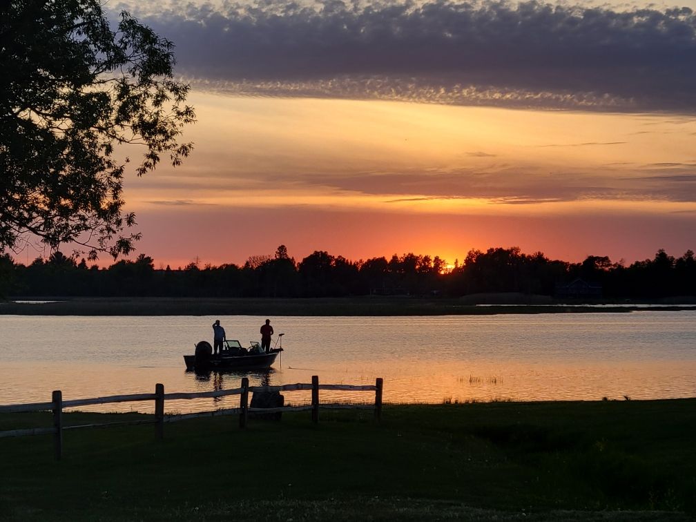 Anglers casting off our dock as the sun goes down over the bay.