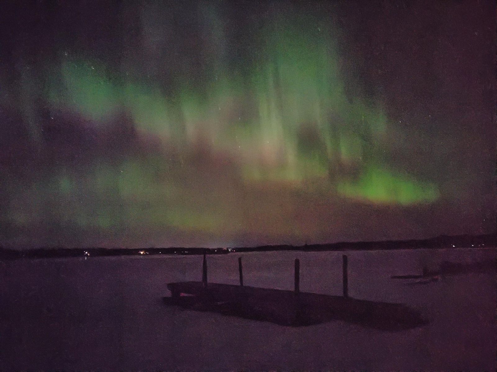 The aurora spread wide over our dock and the still bay.