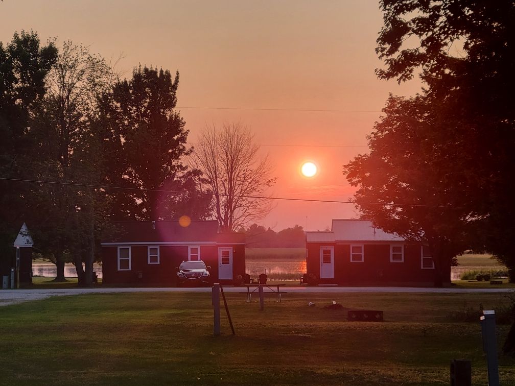 The row of cabins in the haze of an evening sunset.