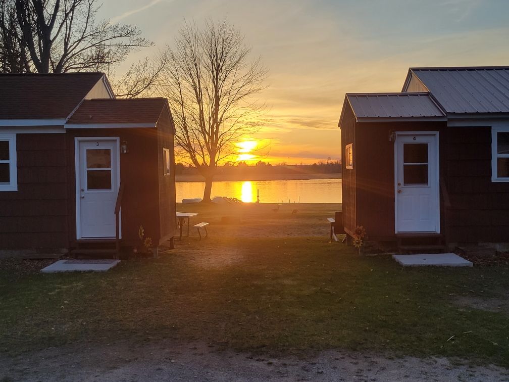 A closer look at the cabins with the sunset dropping between them.