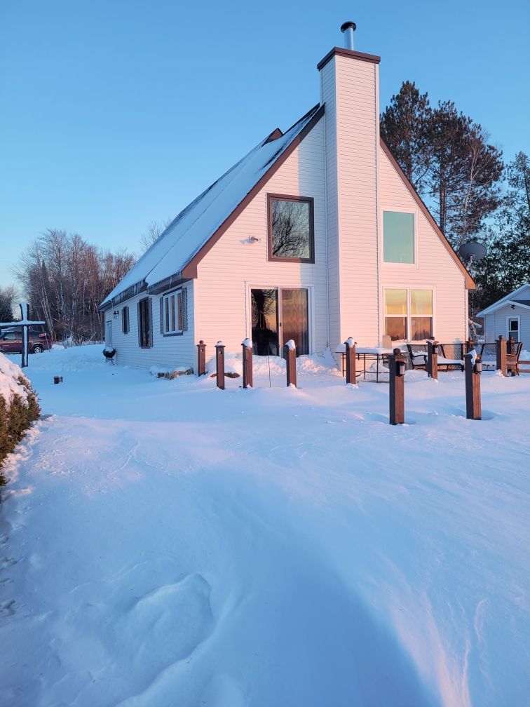 The A-frame lodge buried in deep Upper Peninsula snow.